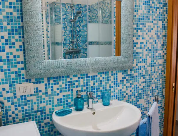 Bagno moderno con mosaico blu e doccia walk-in al B&B Terrazzo sullo Ionio